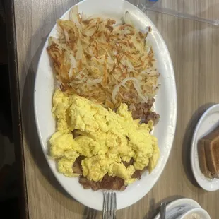 Corn beef, hash and eggs, breakfast with side of sausage, gravy, and wheat toast with water