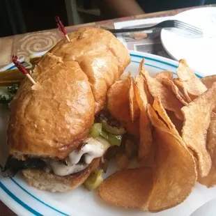 Philly cheese steak sub with kettle cooked chips.
