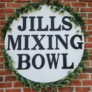 a sign on a brick wall