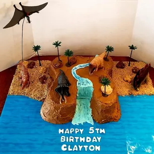 Dinosaur themed birthday cake.  Hand designed and decorated.