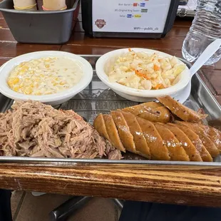 a tray of pulled pork, macaroni, and cheese