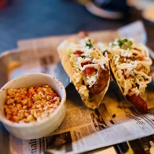 two tacos and a side of corn