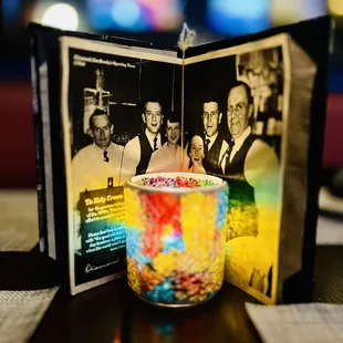 a photo of his family and a candle