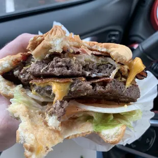 a hand holding a sandwich