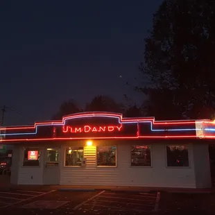 The sign all lit up at night