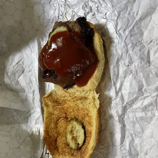 Brisket sandwich with bbq sauce and OH don&apos;t forget that pickle chips! Lol