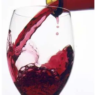 red wine being poured into a wine glass