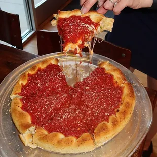 We dove into their signature deep dish, a cheesy masterpiece overflowing with sauce, green peppers, mushrooms, and sausage.