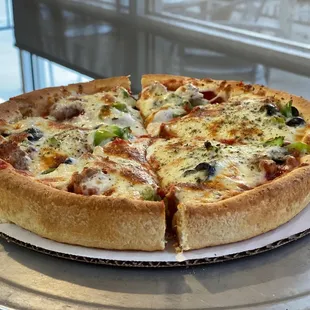 Deep-dish cheese, sausage, green peppers and black olives.