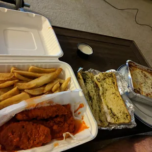Fries, meat lasagna, garlic bread, and buffalo chicken tenders