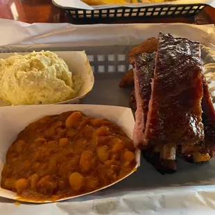 Ribs, potato salad, beans and hush puppies.
