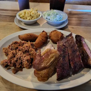 Three meat combo with chopped pork, chicken, ribs, hush puppies, mac &amp; cheese and cole slaw