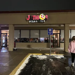 a woman standing in front of a restaurant