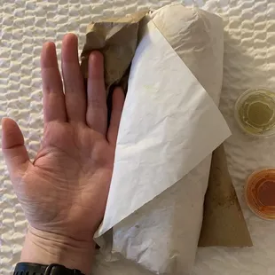 a person's hand holding a piece of paper