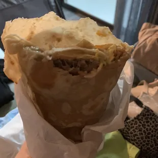 a hand holding a pastry