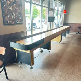 The shuffleboard table and dart board