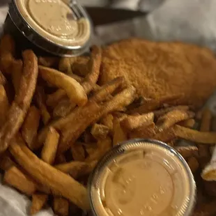 a basket of fried fish and fries