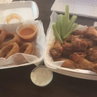 Wings and onion rings and sides of sauce.