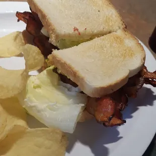 Nice slices of bacon cooked to request of well done and enough lettuce  each sandwich comes with chips