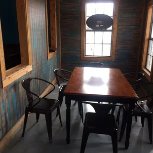 a dining room with a table and chairs