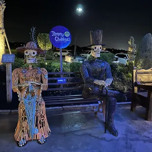 a couple of skeletons sitting on a bench