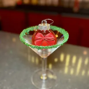 The Coquette Cosmo - vodka, triple sec, lime, rosemary, cranberry, red glitter