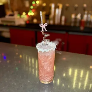 The Frosted Bow - coconut rum, rum, pineapple juice, lime, grenadine, pink glitter, dry ice