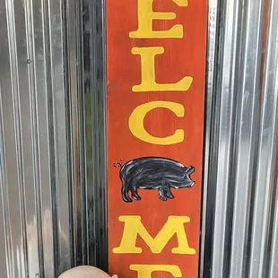 a pig and a sign that says who me