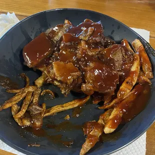 Pulled pork over fries with barbecue sauce