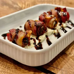 bacon skewers on a bed of whipped cream