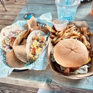 On the left...a Buffalo Caesar &amp; Voodoo taco. On the right...the Burnt Reynolds burger with a side of Cajun fries &amp; a Sprite...