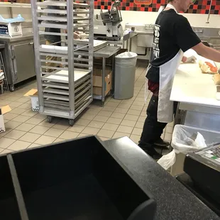 a man preparing food in a commercial kitchen