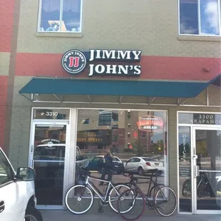 two bikes parked in front of the store