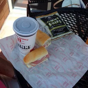 a sandwich and a drink on a table