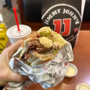 a person holding a sandwich