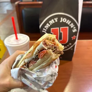 a hand holding a sandwich