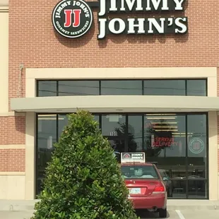 a red car parked in front of the store