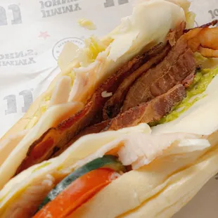 a sandwich with meat and vegetables