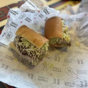 two sub sandwiches on a table