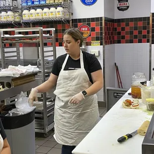 a woman preparing food in a kitchen