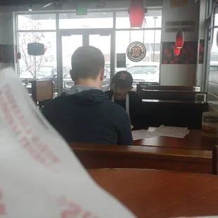 a man sitting at a table in a restaurant