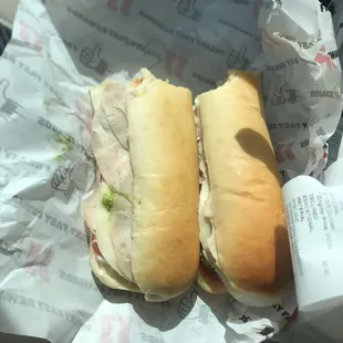two sub sandwiches in wrappers