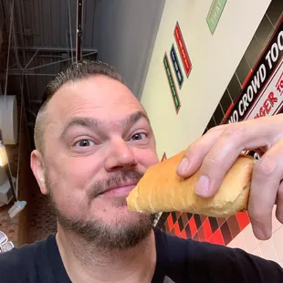 a man eating a hot dog