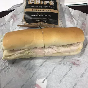 a sub sandwich and chips