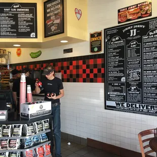 a man standing in front of a menu