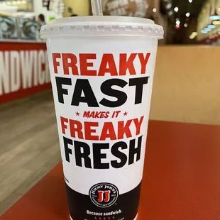 a drink in a plastic cup with a straw