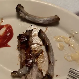 a plate of ribs and ketchup