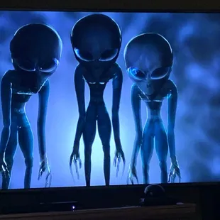 three aliens on a television screen