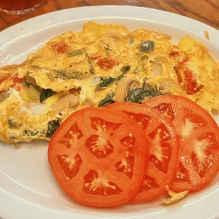 Veggie omelette with fresh and delicious sliced tomatoes.