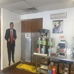 Area behind the counter, doorway leads to kitchen area